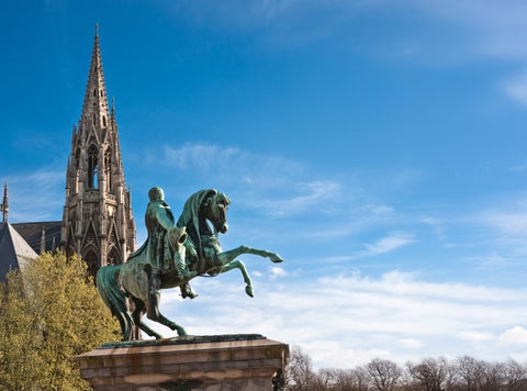 Statue with the Cathedral of Notre-Dame in the background at Rouen City Center, France