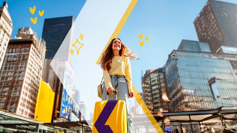 Girl with a luggage in the street surrounding by buildings