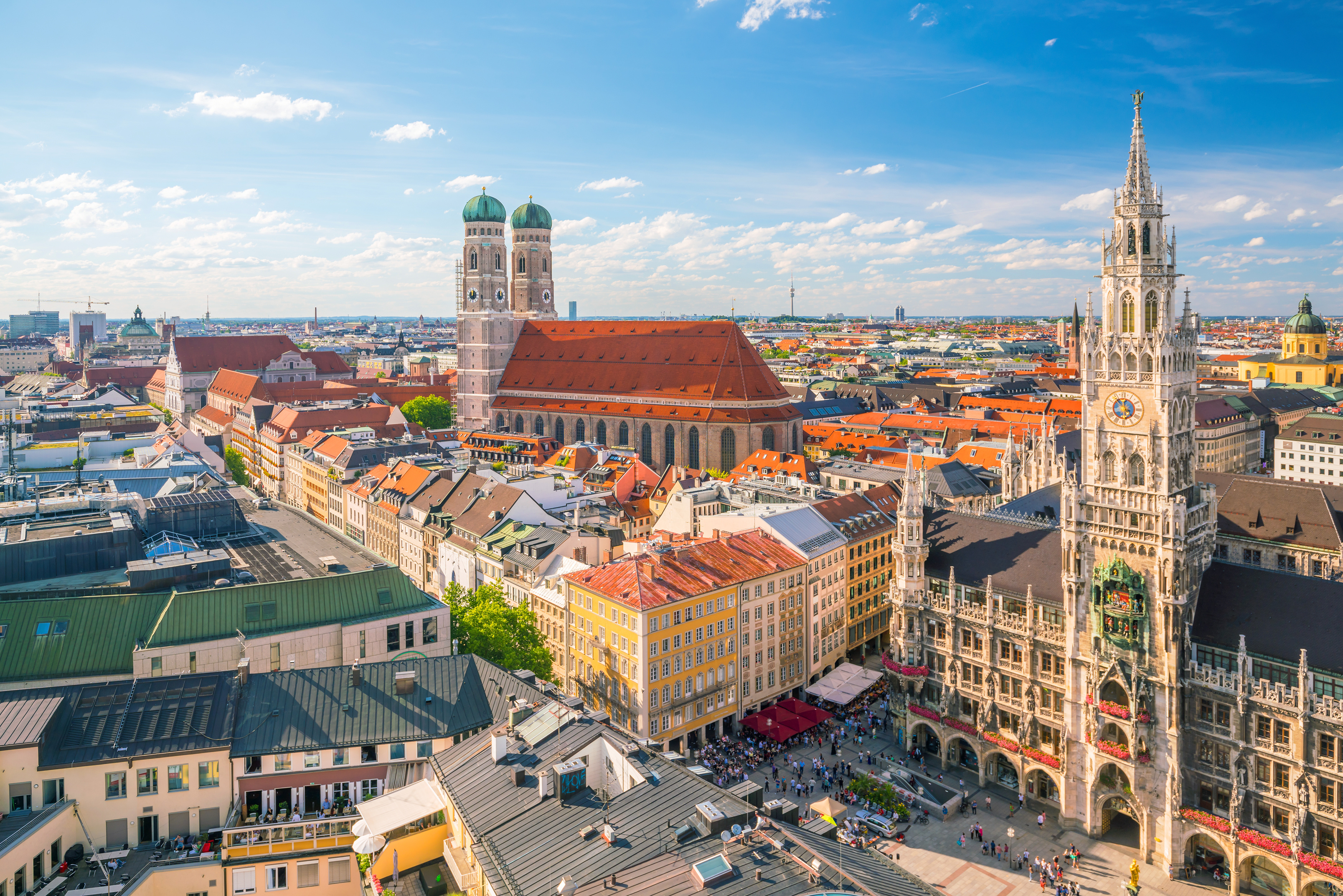 An aerial view of the historic center of Munich with its red-roofed buildings of Marienplatz, Frauenkirche and the neo-gothic New Town Hall