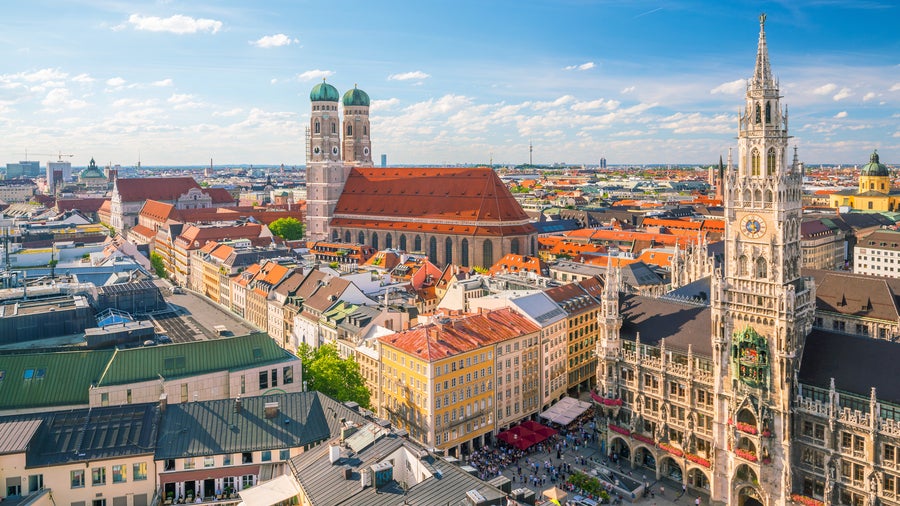 An aerial view of the historic center of Munich with its red-roofed buildings of Marienplatz, Frauenkirche and the neo-gothic New Town Hall