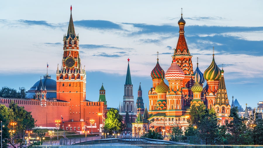 Colourful domes of St. Basil's Cathedral with the historic GUM Department Store next to it in Moscow, Russia