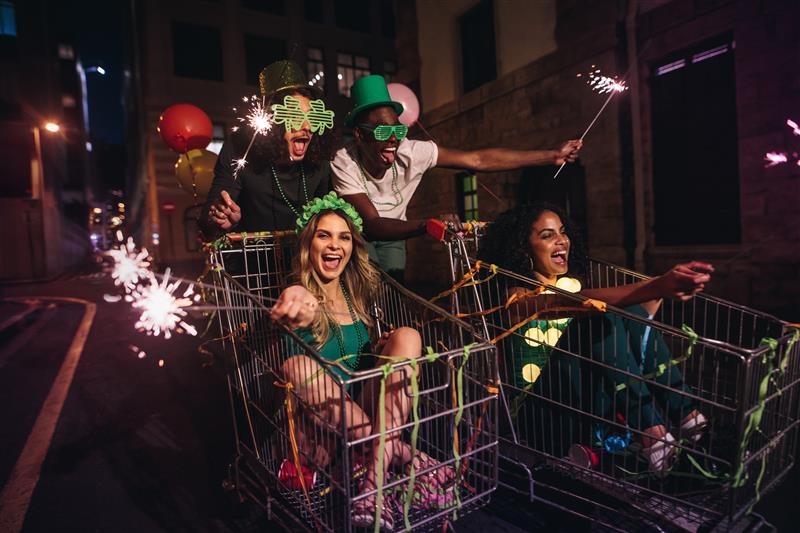 group of four friends in a wild and ecstatic celebration for St. Patrick's Day.
