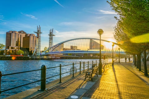 Sunset reflecting on the water at Salford Quays, Manchester with modern buildings