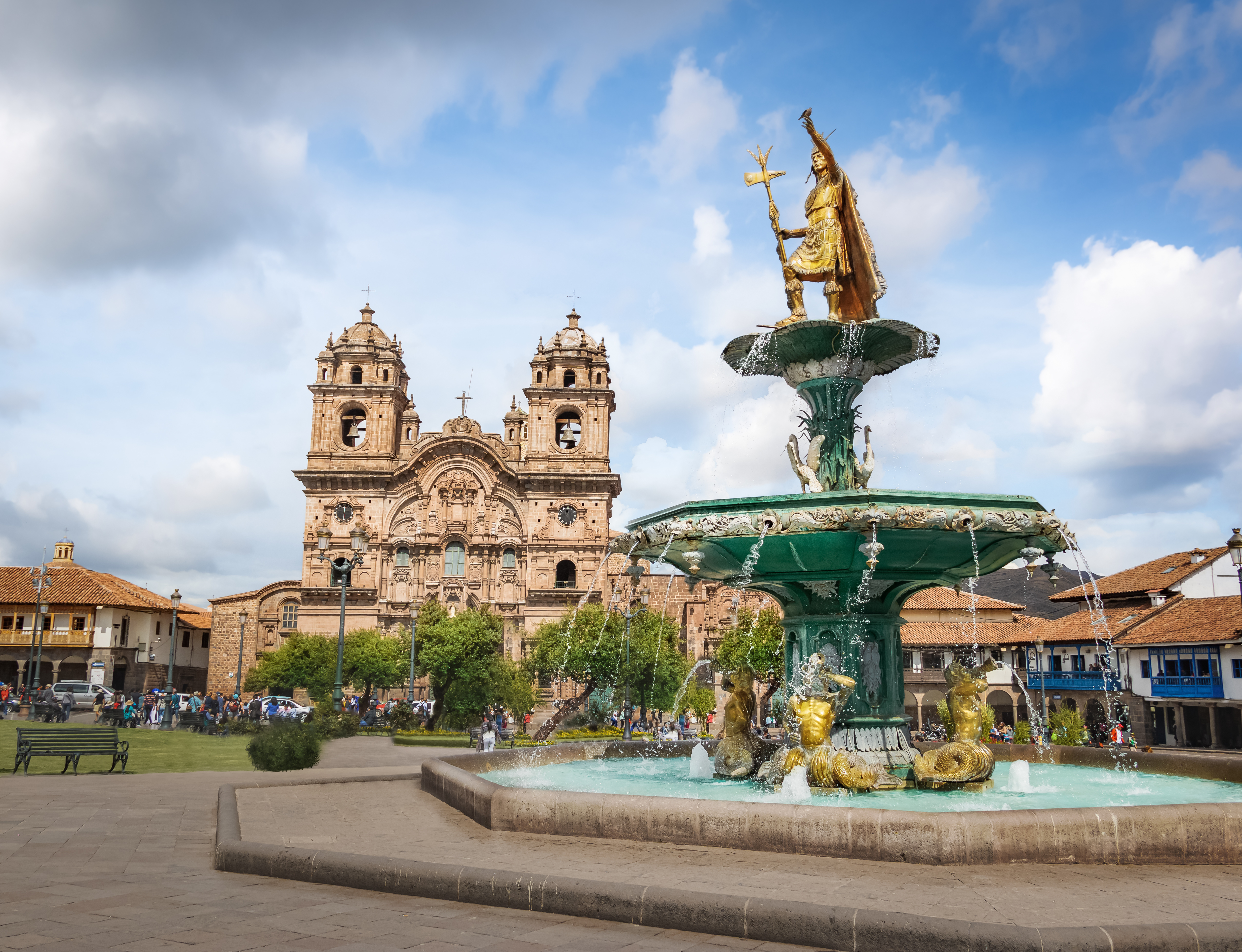 City center of Cusco, Peru featuring the Fountain of the Inca and the historic Church of the Society of Jesus in the background