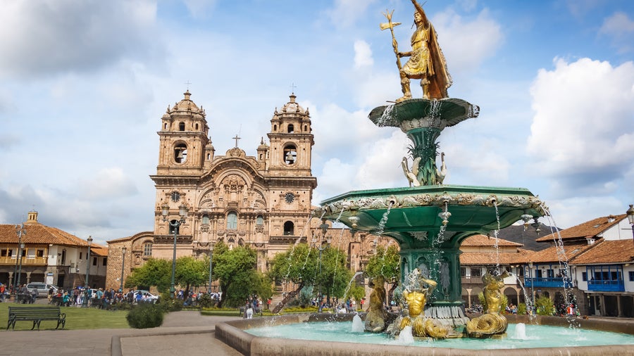 City center of Cusco, Peru featuring the Fountain of the Inca and the historic Church of the Society of Jesus in the background