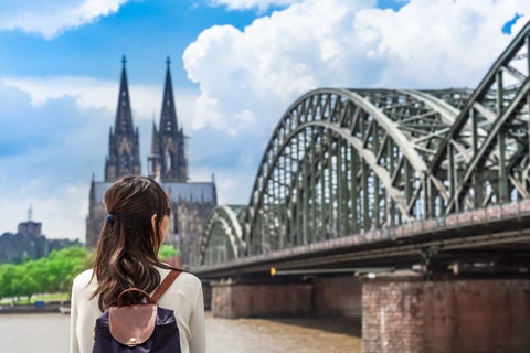 Tourists enjoying the view from the Hohenzollern Bridge spanning the Rhine River with Cologne Cathedral in the background, Cologne, Germany