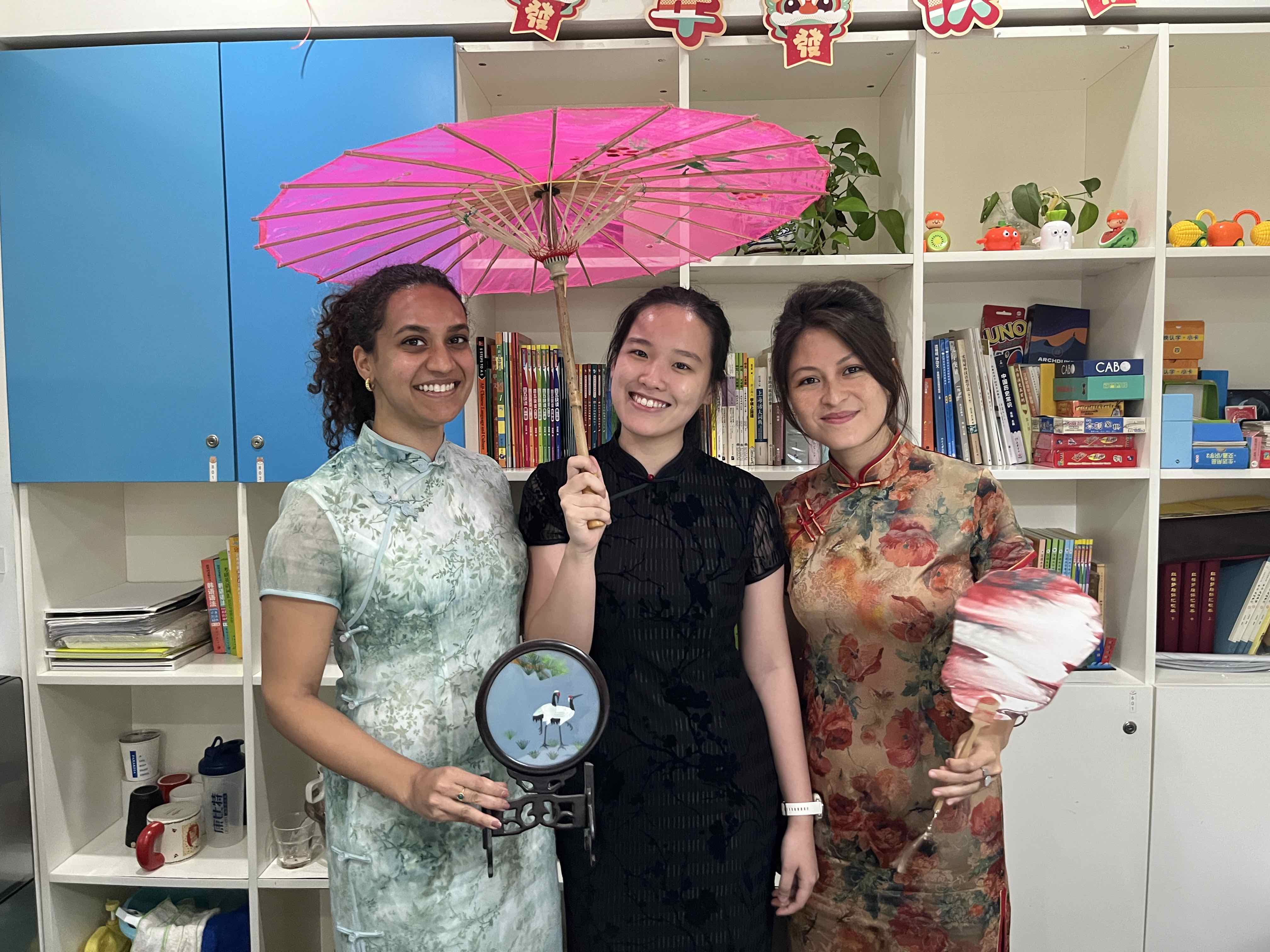 Three students wearing traditional Chinese costumes