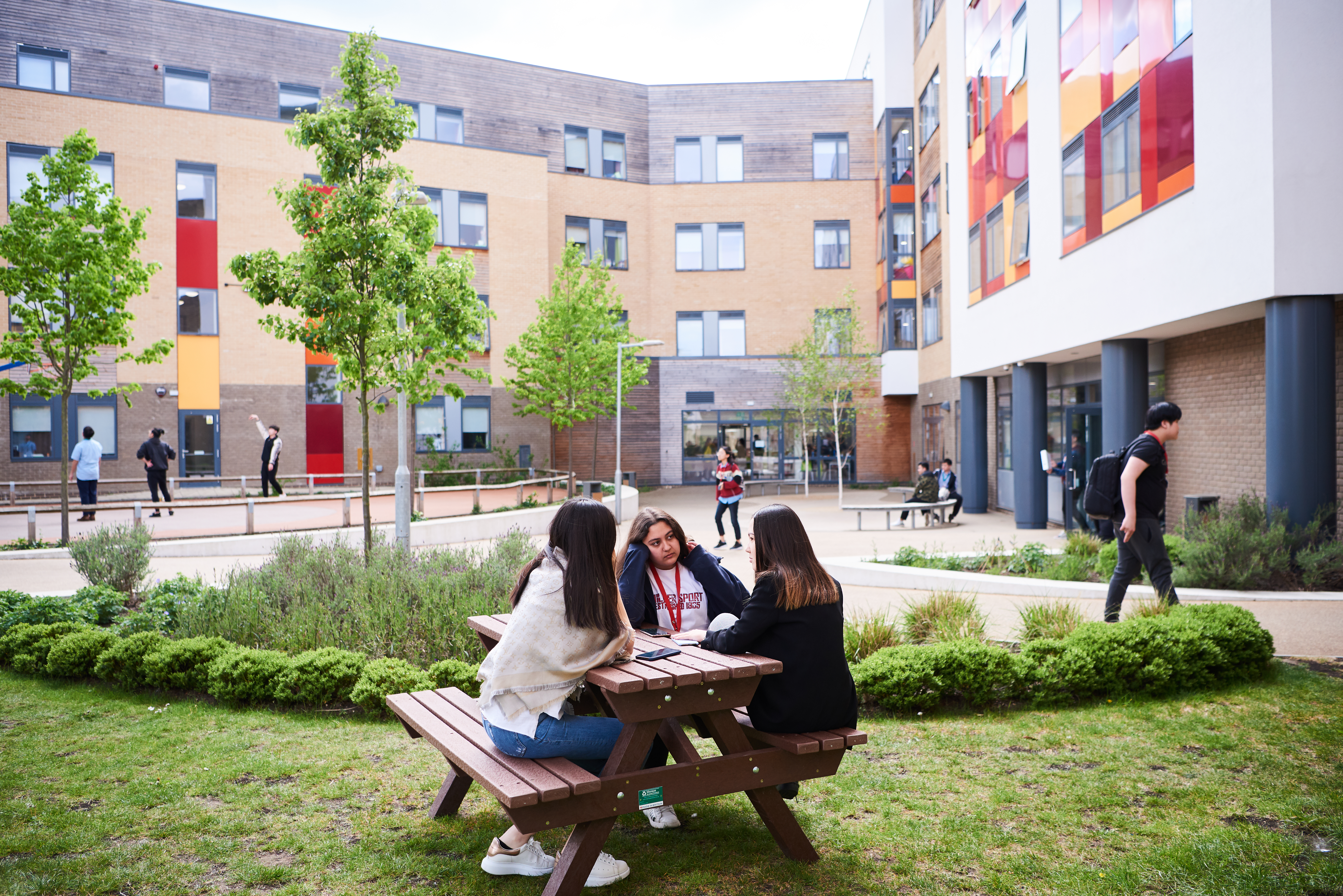A group of students sitting at the garden