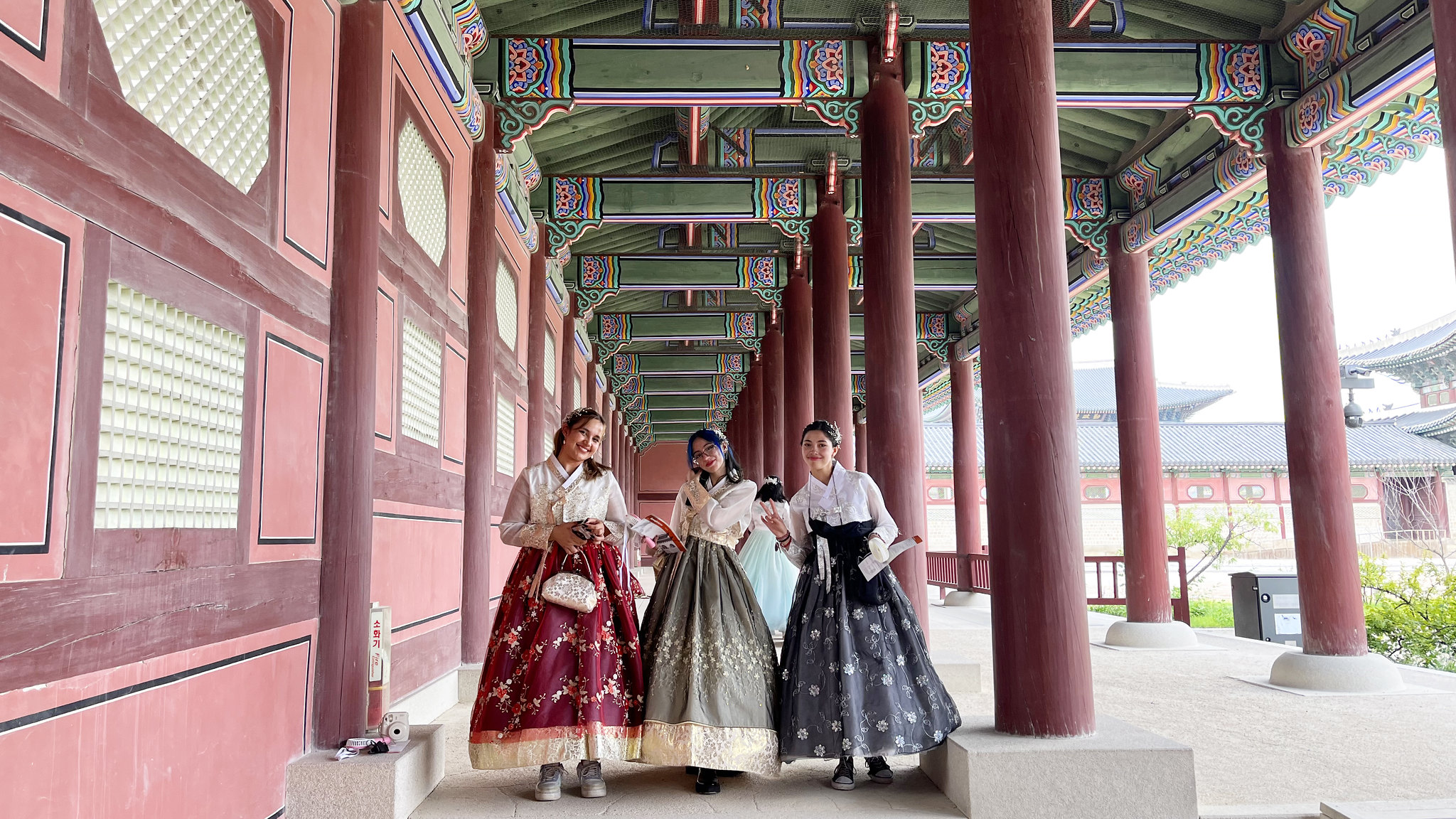 Three students wearing traditional Korean costumes