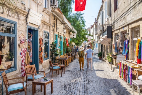 Tourists walking along busy streets with shops in Izmir, Turkey