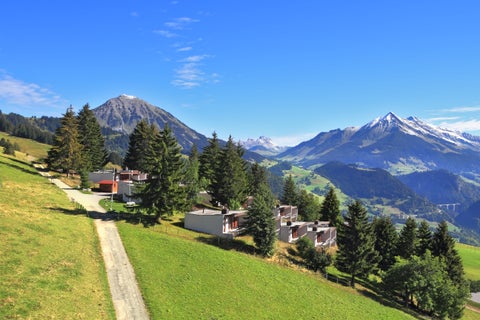 Sunny day in the resort town of Leysin in the Swiss Alps, with clear skies and panoramic mountain views