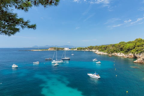 Boats at vibrant blue ocean in the French Riviera at Antibes, France