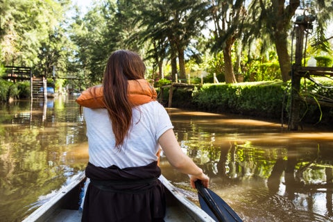 Tourist enjoying a boat ride on the river in Buenos Aires, surrounded by city views