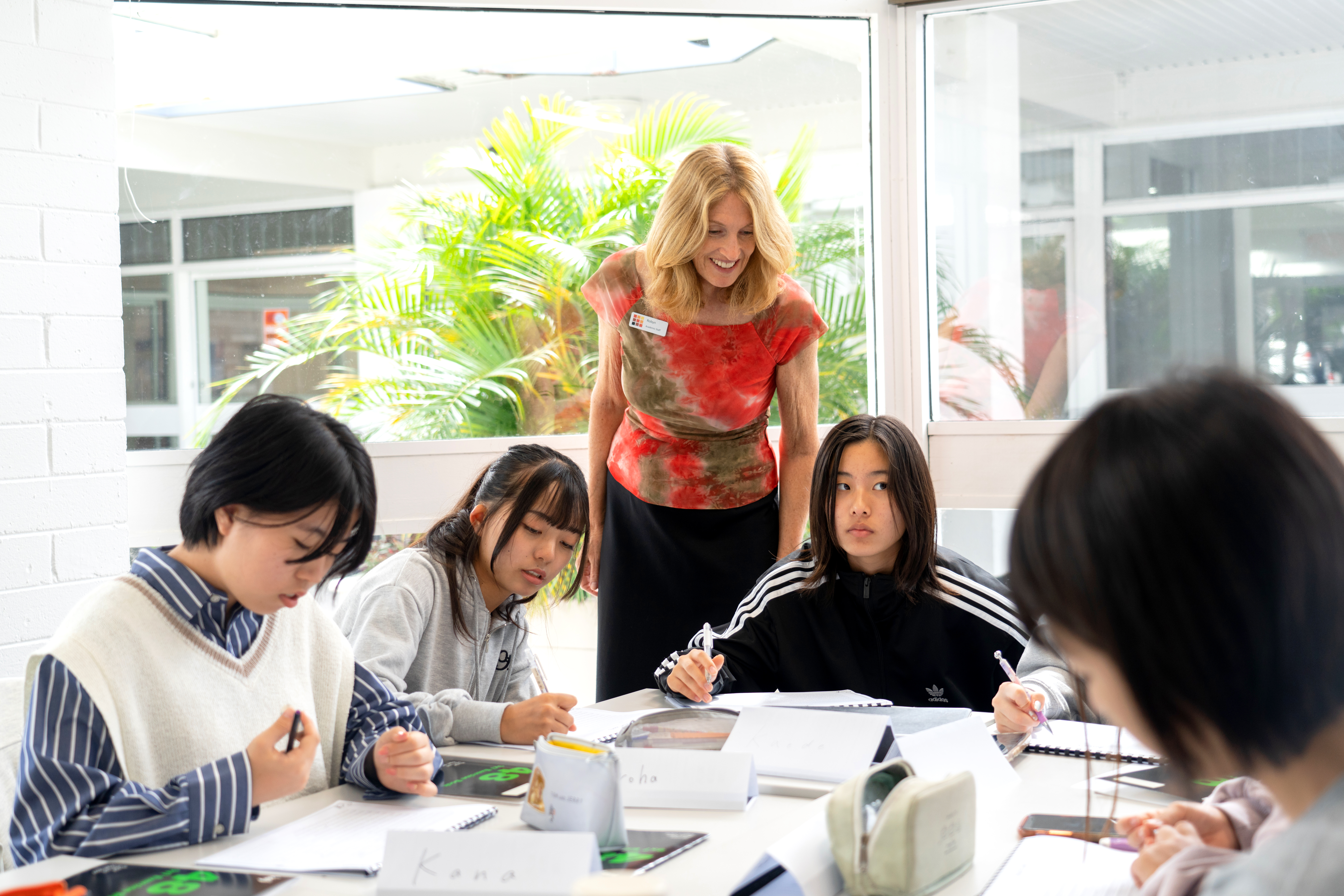 A teacher helping her students at Noosa College