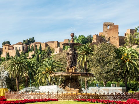 Fuente de Génova fountain in Málaga, Spain, with the historic Palacio Episcopal building in the background