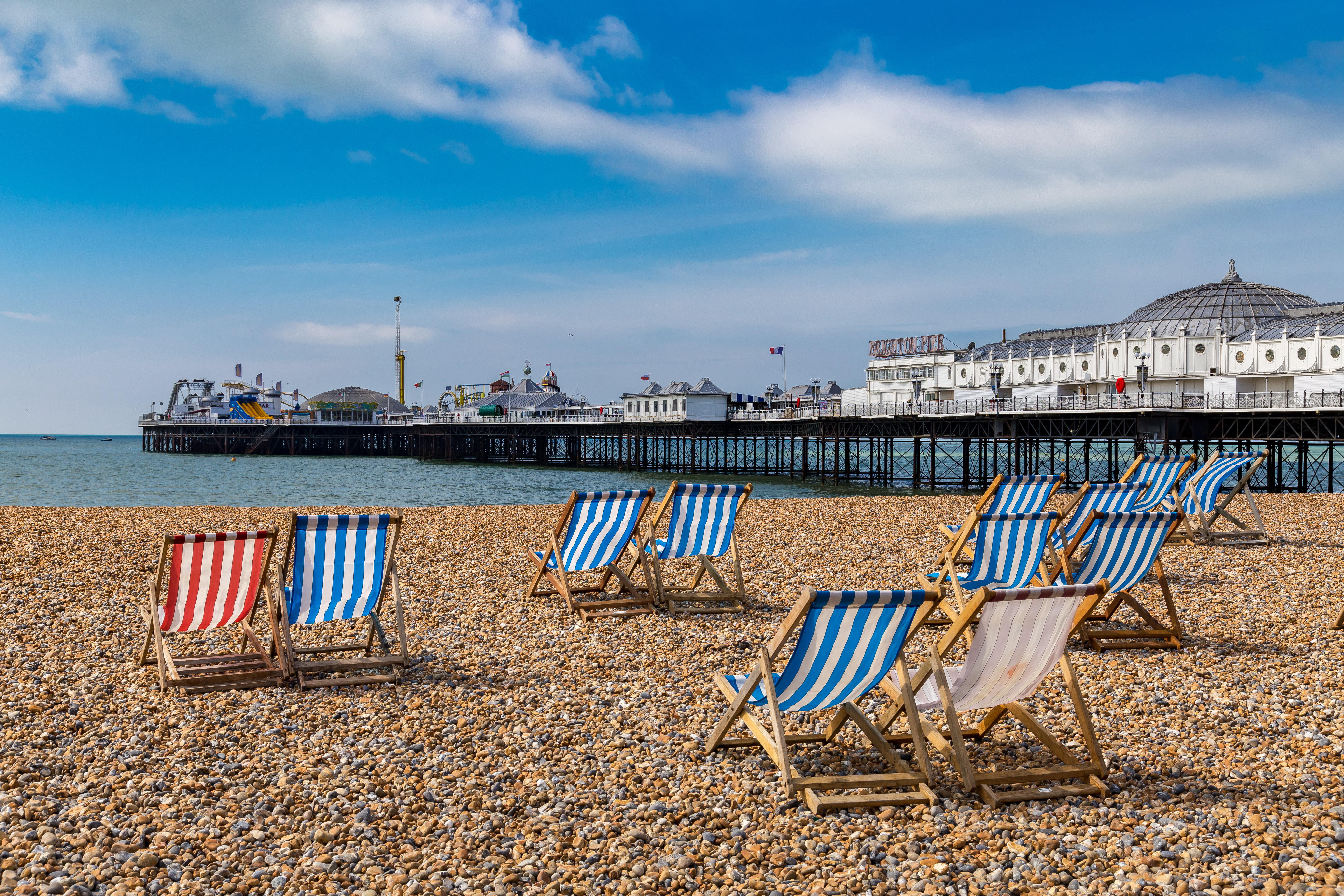Colorful beach chairs lined up on Brighton beach, United Kingdom