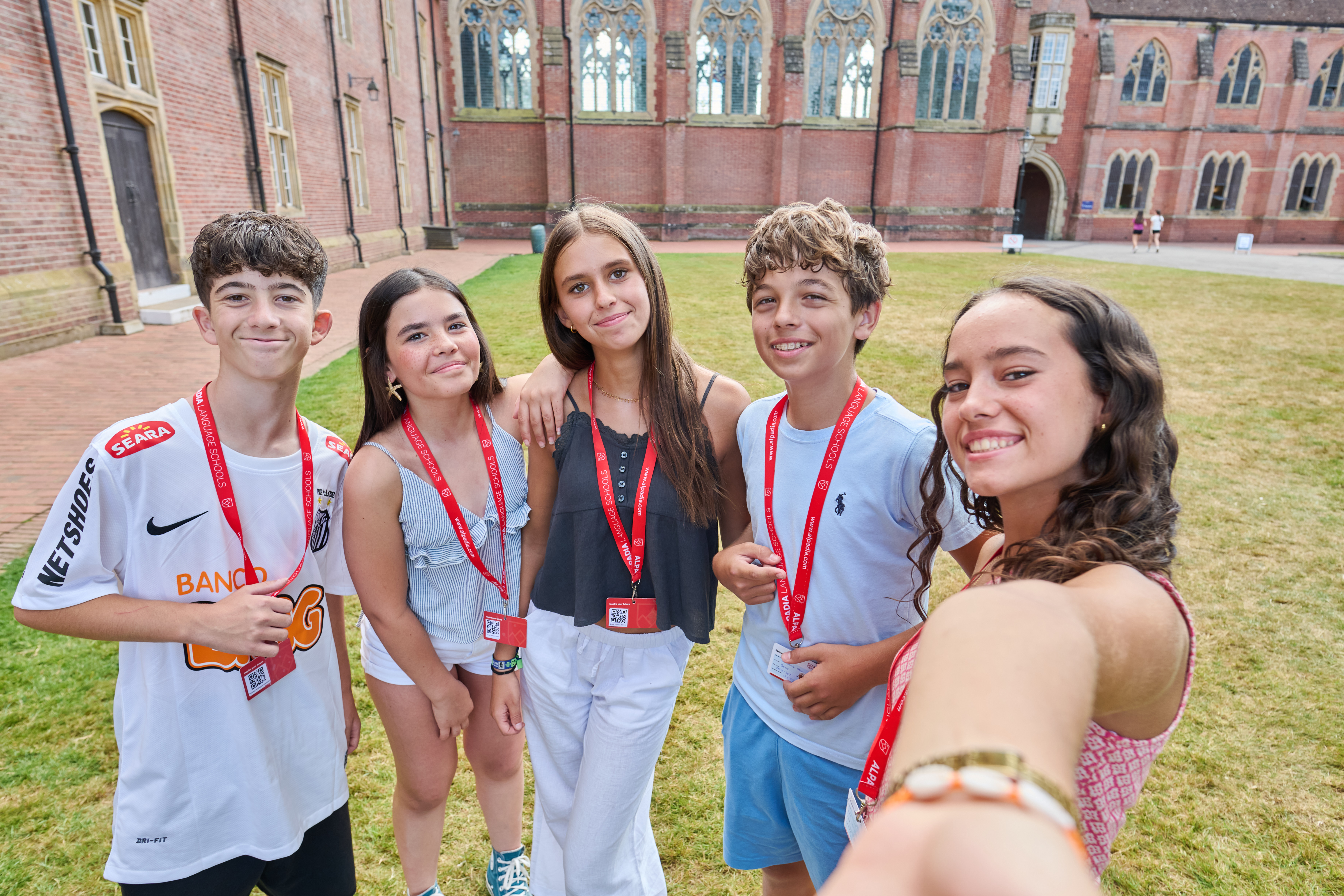International teen students taking a selfie together outside their school in Ardingly, United Kingdom