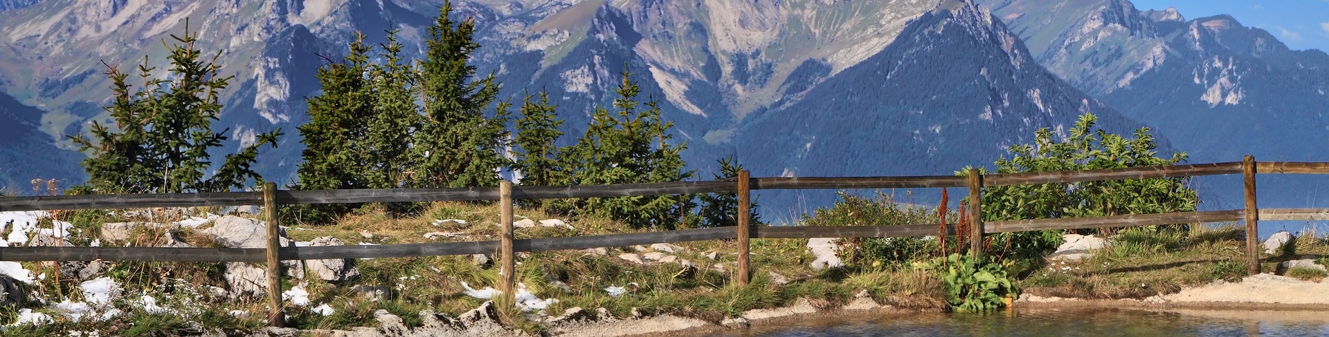Scenic view of Leysin, Switzerland, featuring nearby mountain lakes and the surrounding alpine peaks including Tour d'Aï and Dent de Morcles