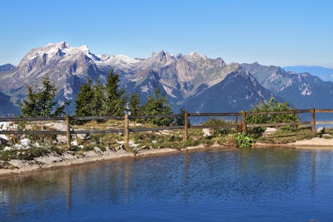 Scenic view of Leysin, Switzerland, featuring nearby mountain lakes and the surrounding alpine peaks including Tour d'Aï and Dent de Morcles