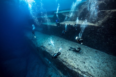 Scuba diver exploring colourful underwater marine life and coral reefs in Okinawa, Japan