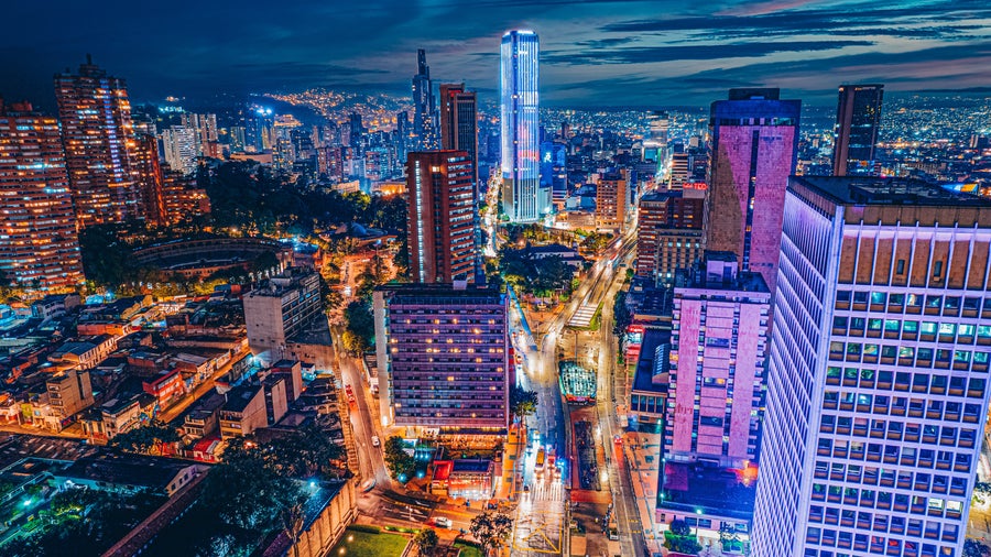 Urban landscape of Bogota City center at night, with modern skyscrapers, historic architecture