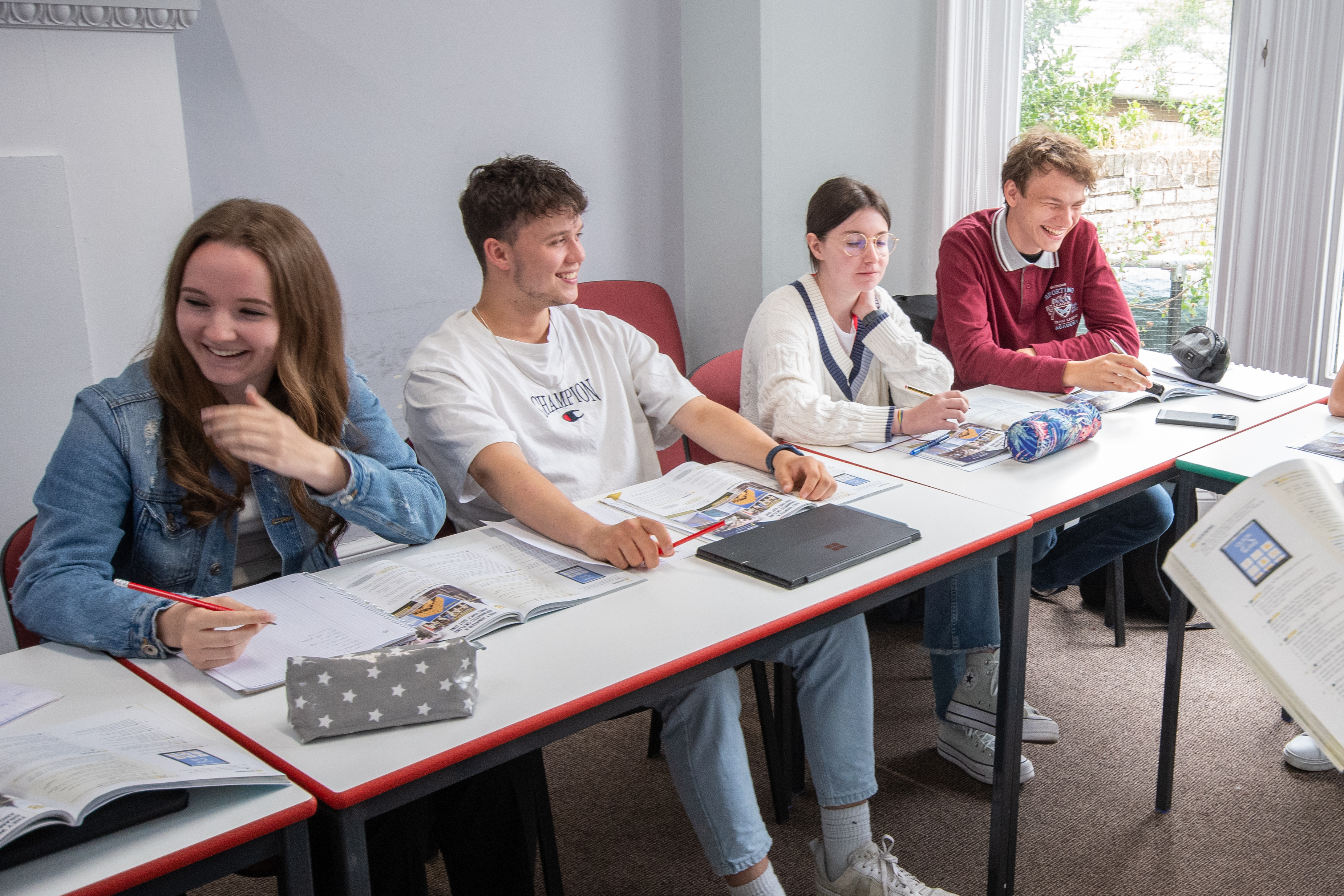 Four students in class at Cambridge College Programme