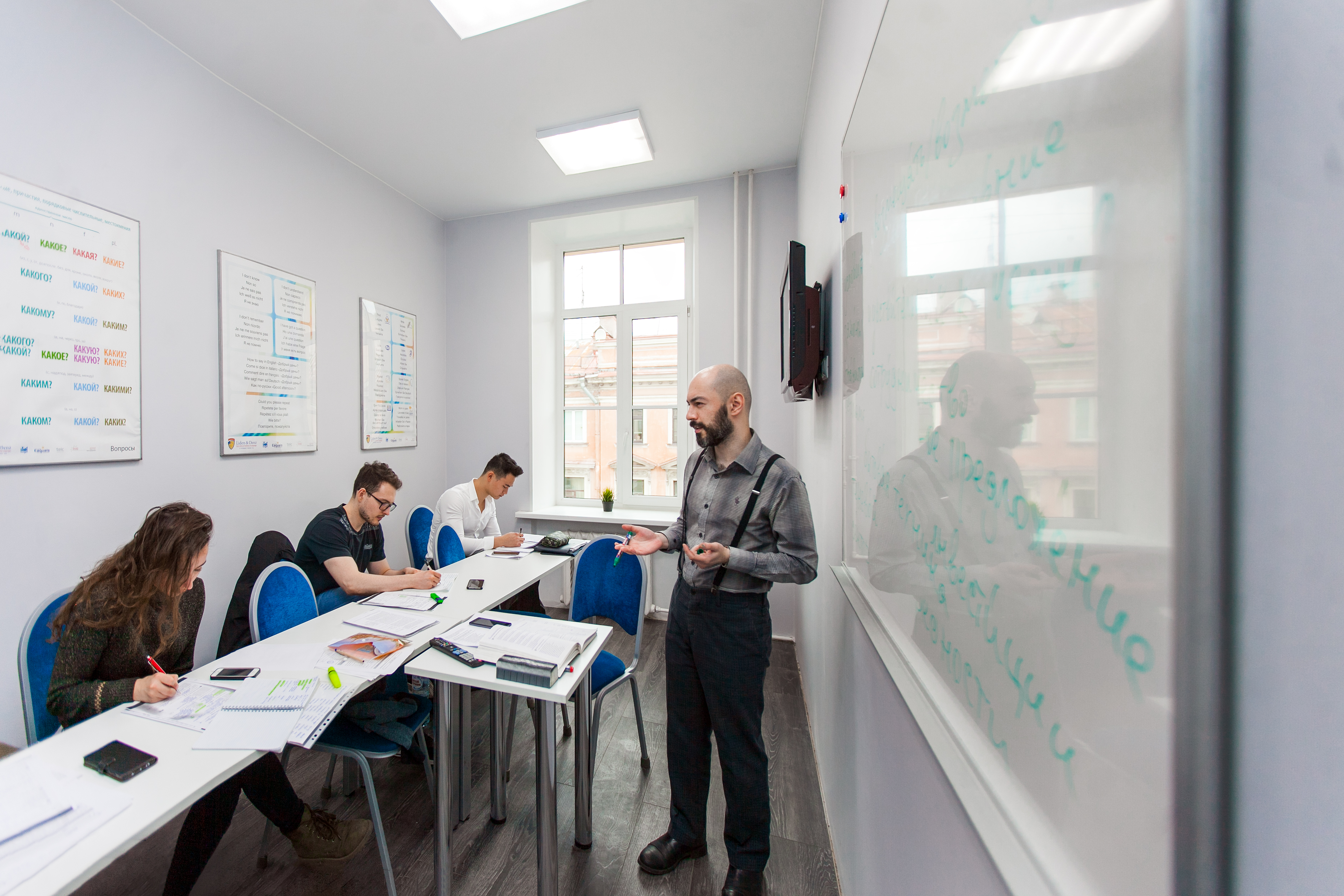 A teacher with his students at Liden & Denz St. Petersburg
