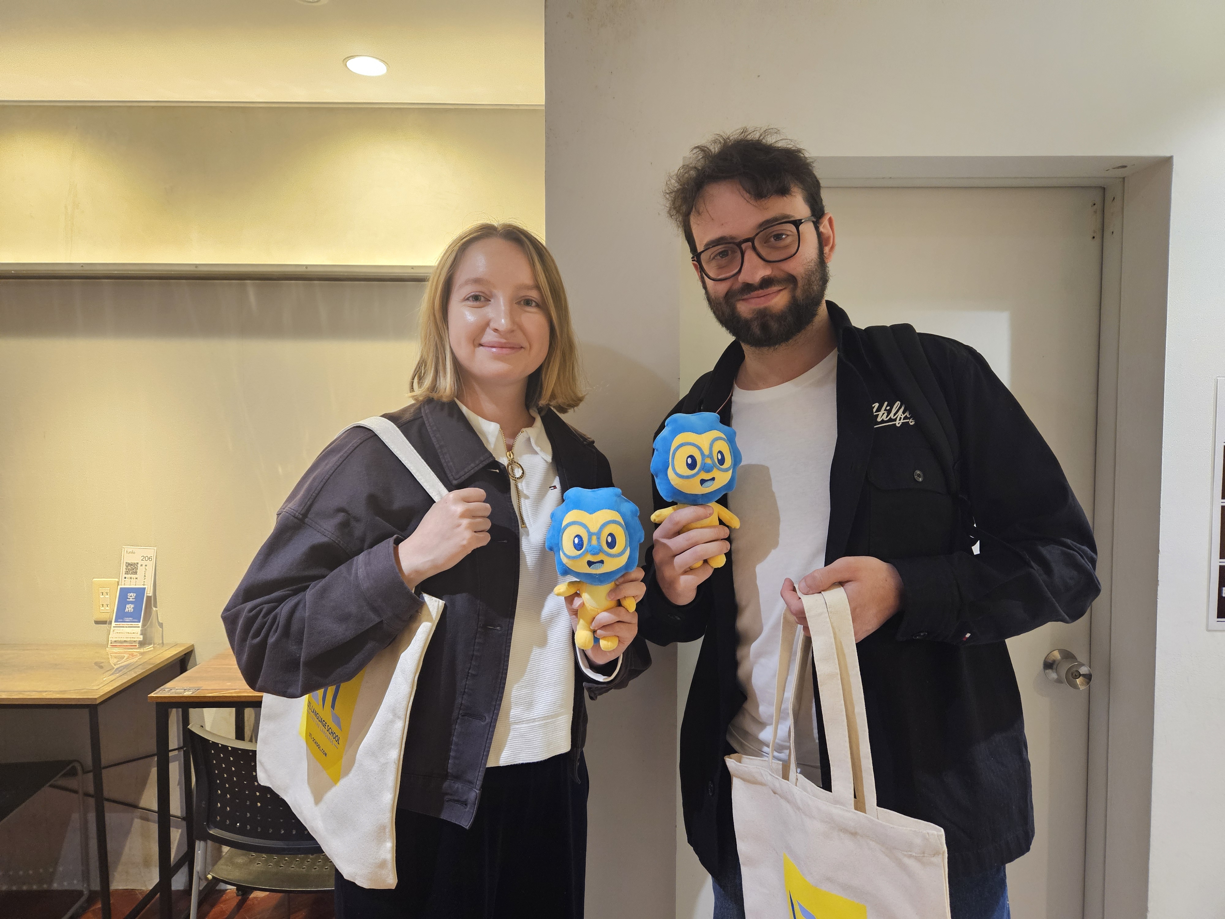 Two students with LTL Osaka merchandising