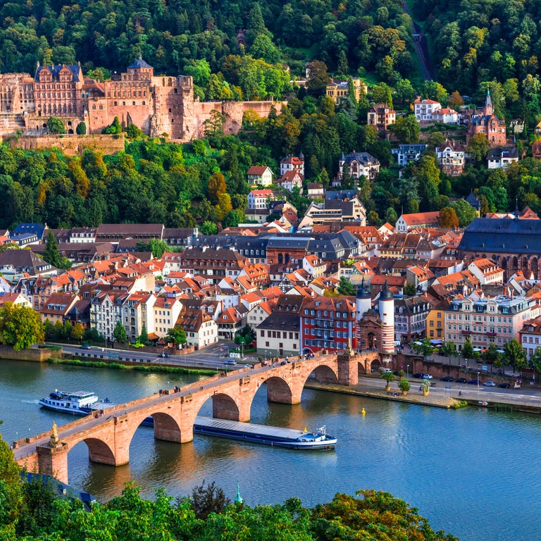 Heidelberg's Old Town with its medieval streets, the historic Heidelberg Castle perched on the hillside, and the iconic Old Bridge spanning the Neckar River