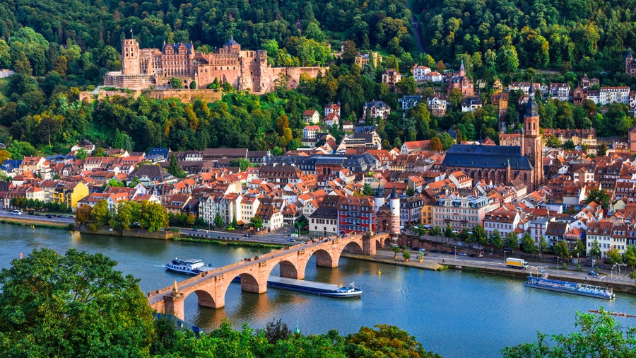 Heidelberg's Old Town with its medieval streets, the historic Heidelberg Castle perched on the hillside, and the iconic Old Bridge spanning the Neckar River