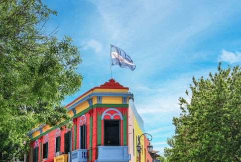Brightly painted house in La Boca, Buenos Aires, showcasing vibrant blues, reds, and yellows