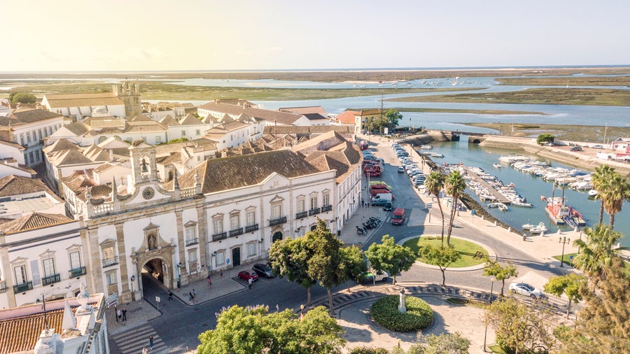 Aerial view of Faro, Portugal, showing the Old Town (Cidade Velha), Arco da Vila, Faro Marina, and Ria Formosa Natural Park