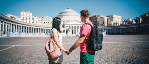 Couple exploring Piazza del Plebiscito in Naples, Italy