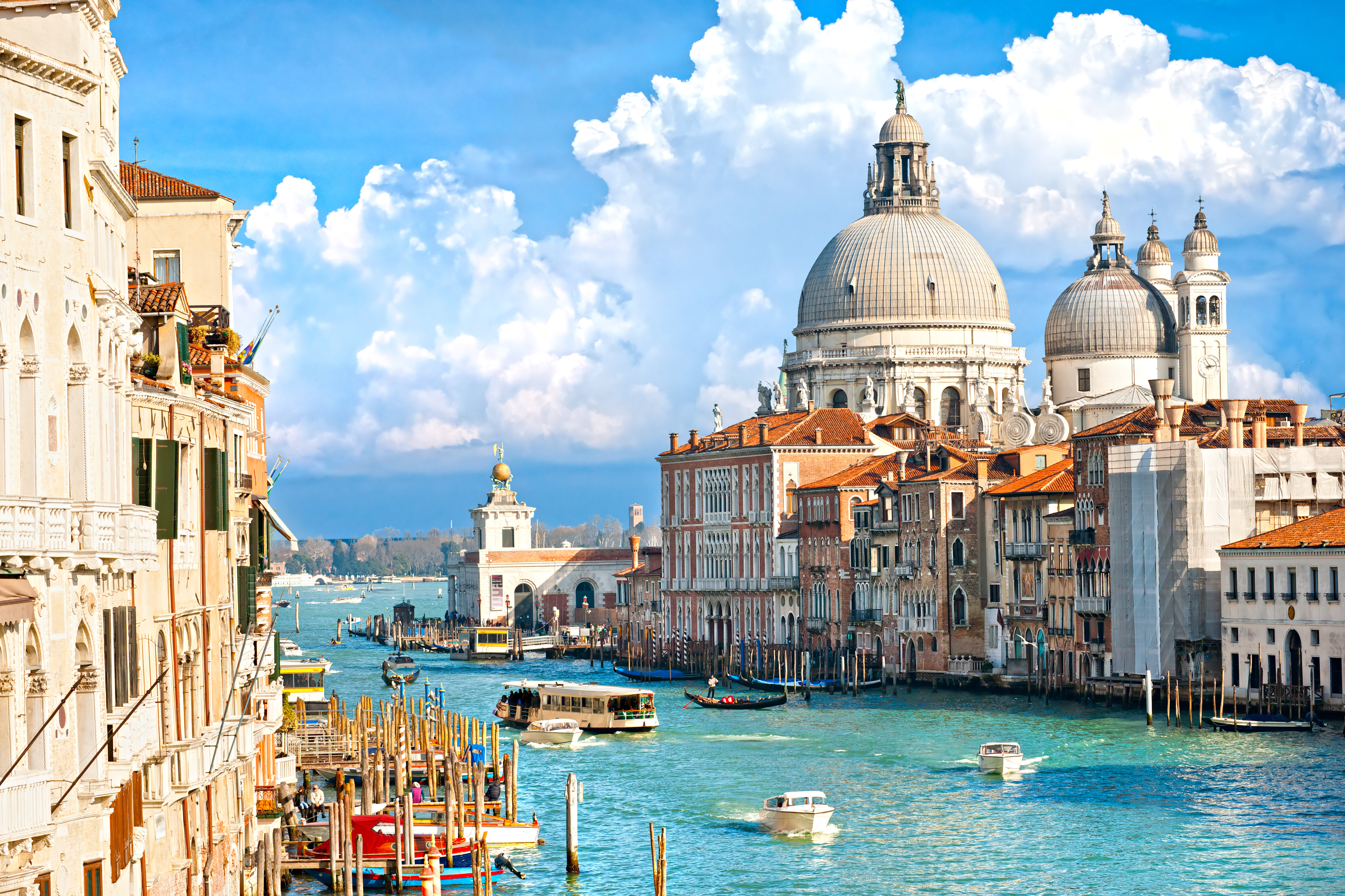 Boats in the canals at Venice city center with St. Mark’s Basilica visible in the background