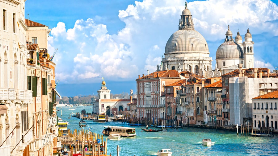 Boats in the canals at Venice city center with St. Mark’s Basilica visible in the background
