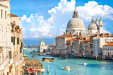 Boats in the canals at Venice city center with St. Mark’s Basilica visible in the background