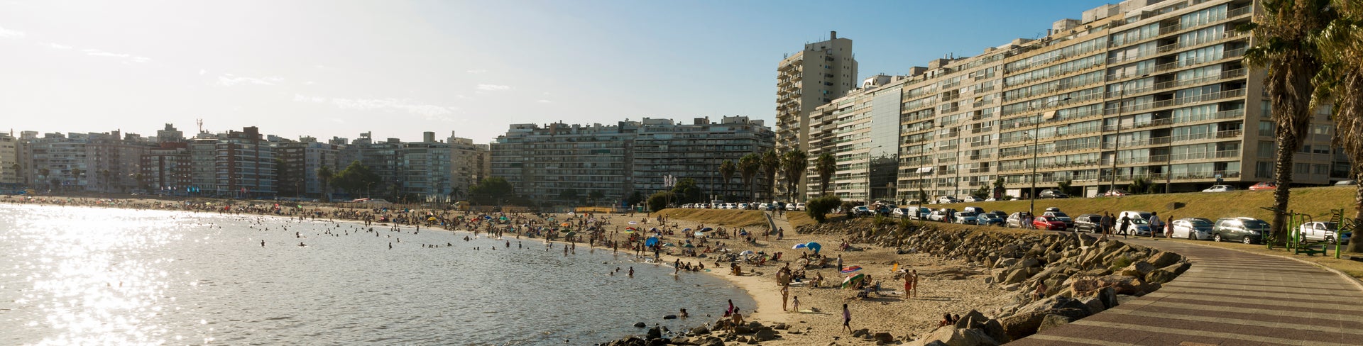 Sunset over Pocitos Beach in Montevideo, Uruguay, with bathers enjoying a summer day
