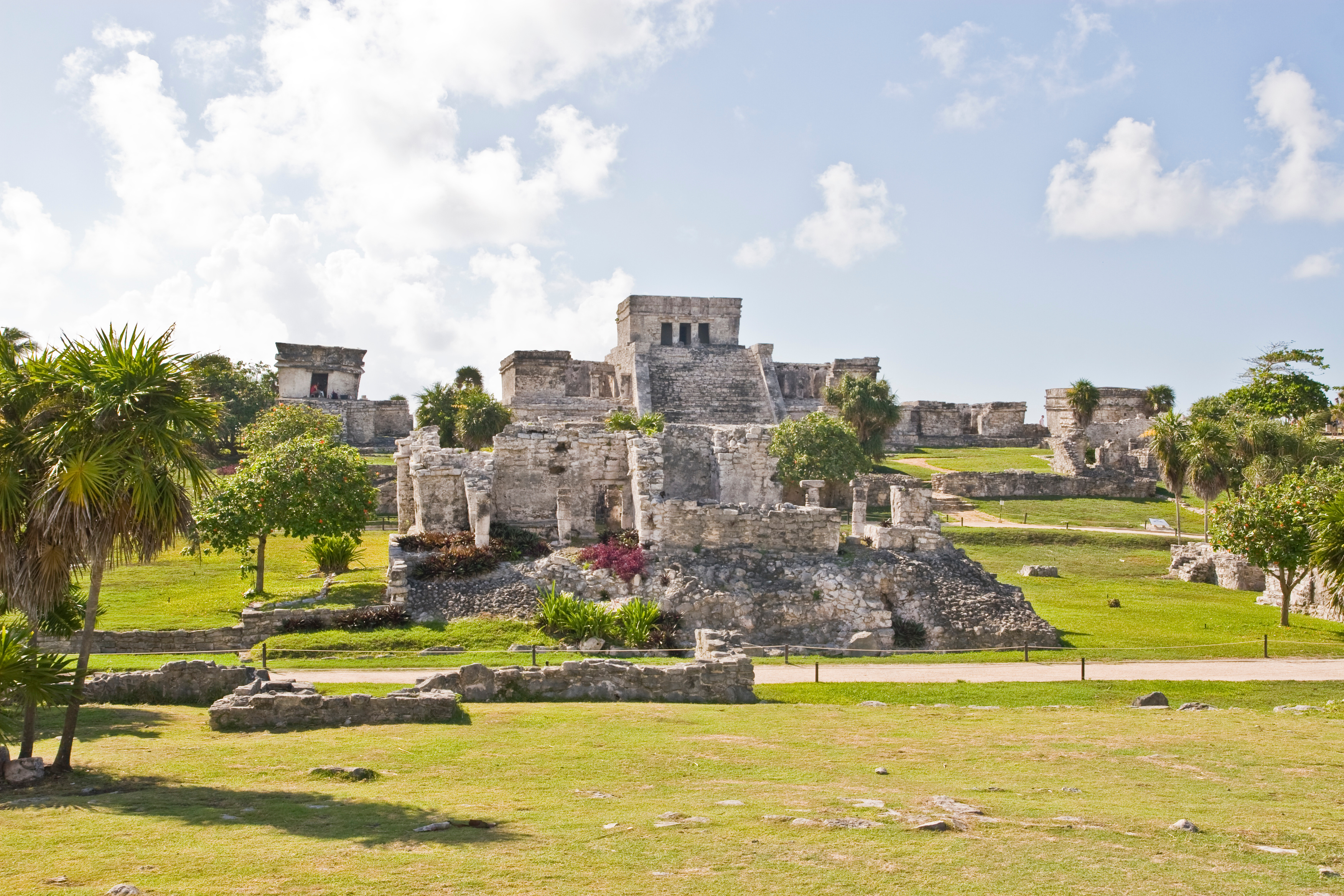 Chichén Itzá surrounded by lush greenery and ancient Maya ruins near Playa Del Carmen, Mexico