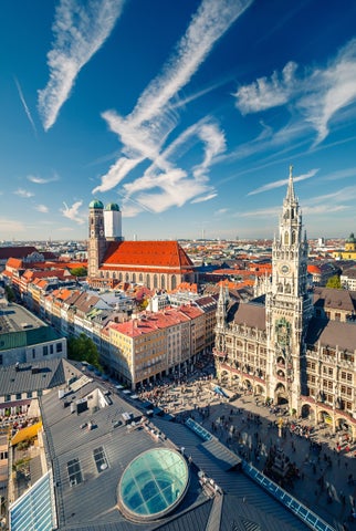 An aerial view of the historic center of Munich with its red-roofed buildings of Marienplatz, Frauenkirche and the neo-gothic New Town Hall