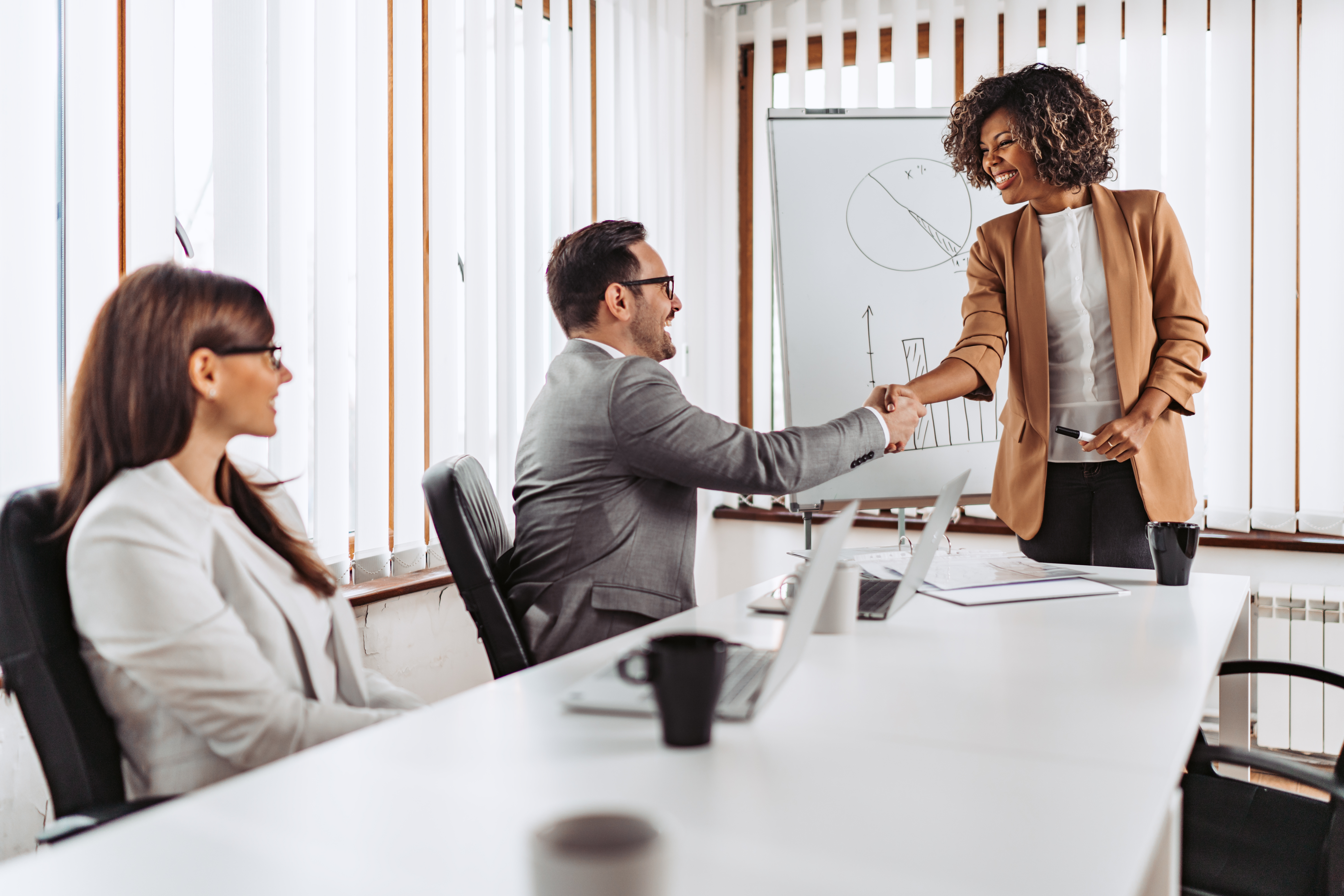 Woman giving presentation with graphics during a business meeting indoors