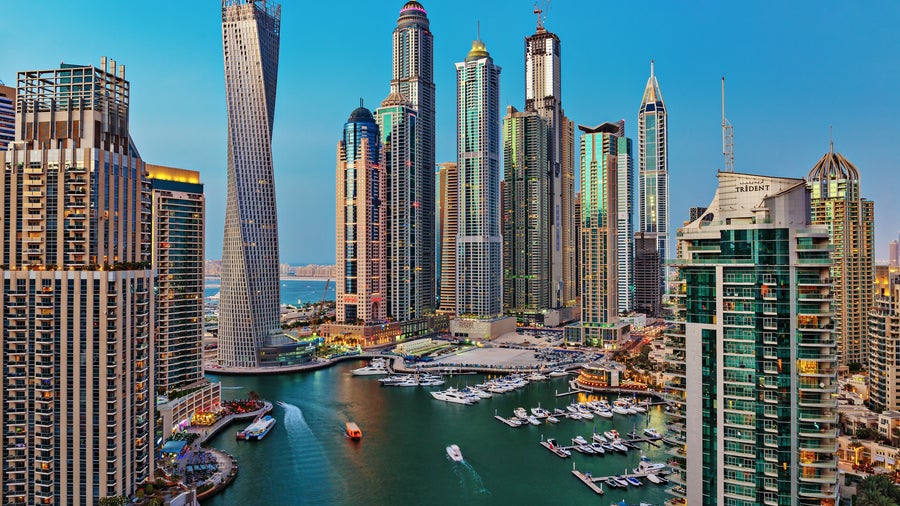 Twilight aerial view of Dubai Marina with yachts and boats on the Persian Gulf waters