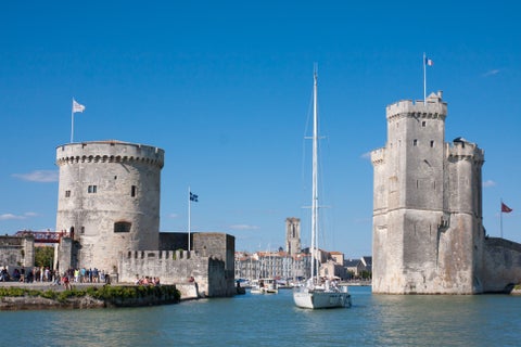 Boat at the ocean between historic buildings in La Rochelle, France