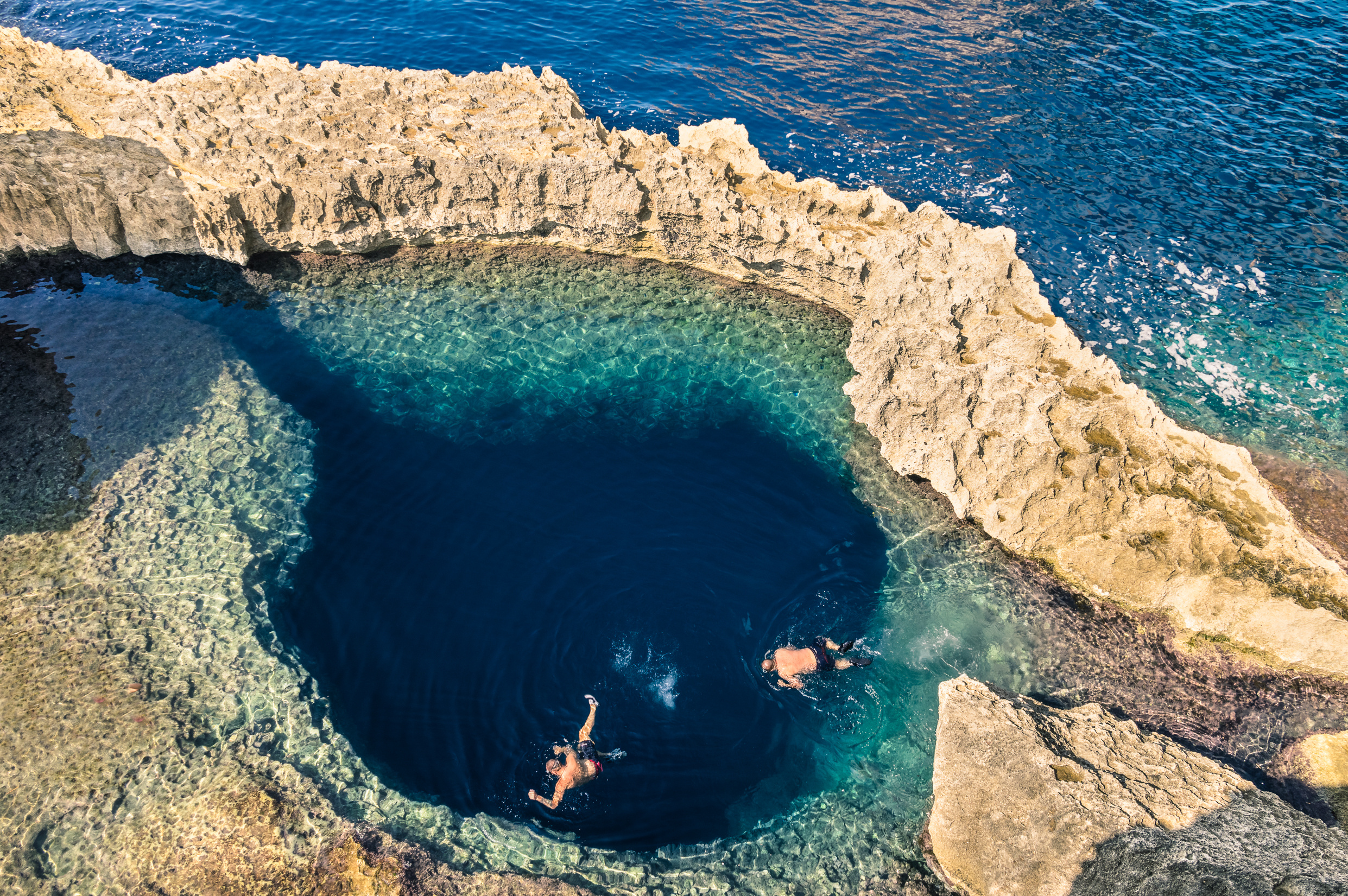 a natural sea pool, often referred to as a "blue hole."