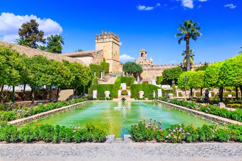 Historic landmark Alcázar de los Reyes Cristianos in Córdoba, Spain, featuring a garden with a central water pool