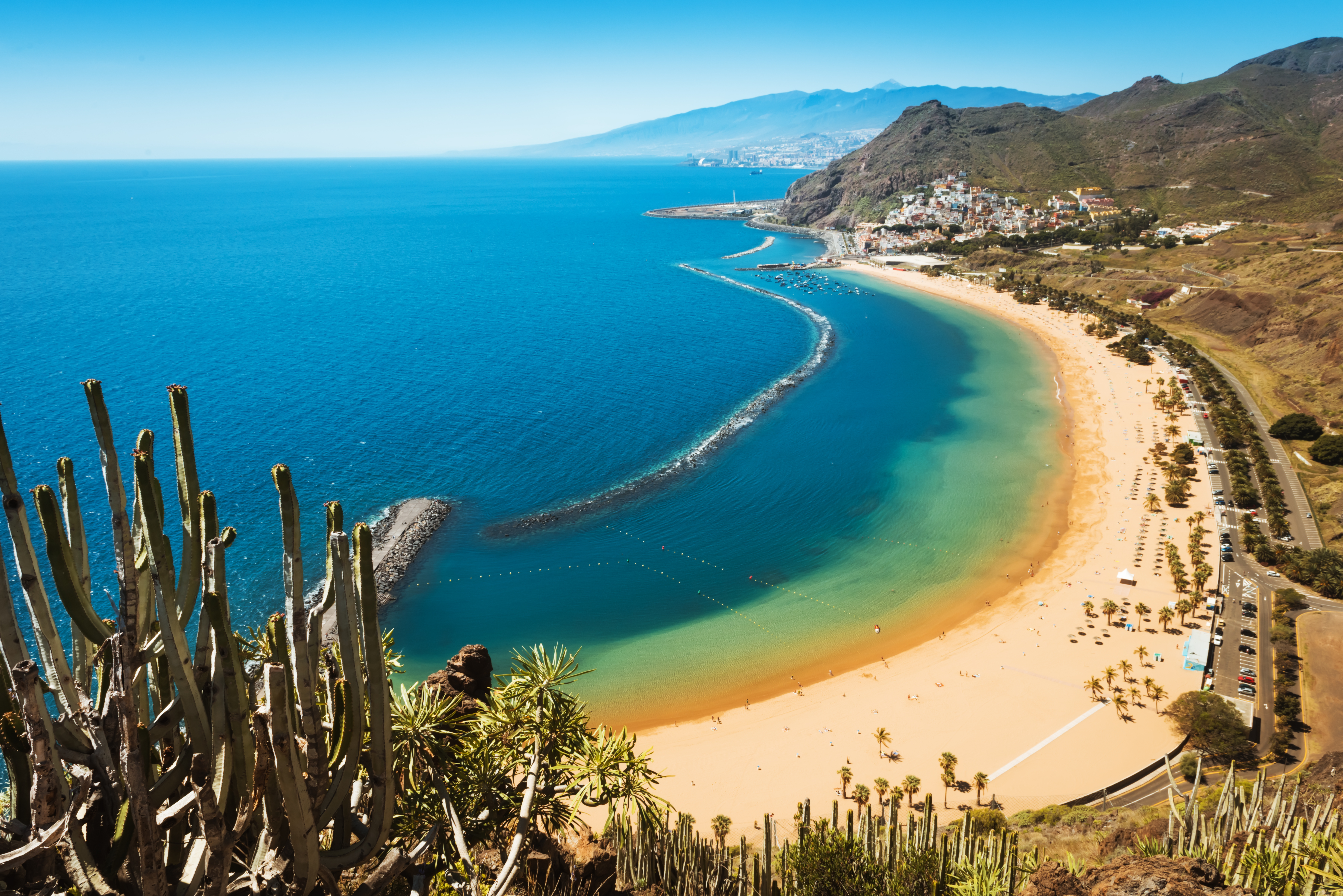 Aerial view of Playa de Las Teresitas beach in Tenerife, Spain, with the Anaga Mountains in the background and golden sandy shore