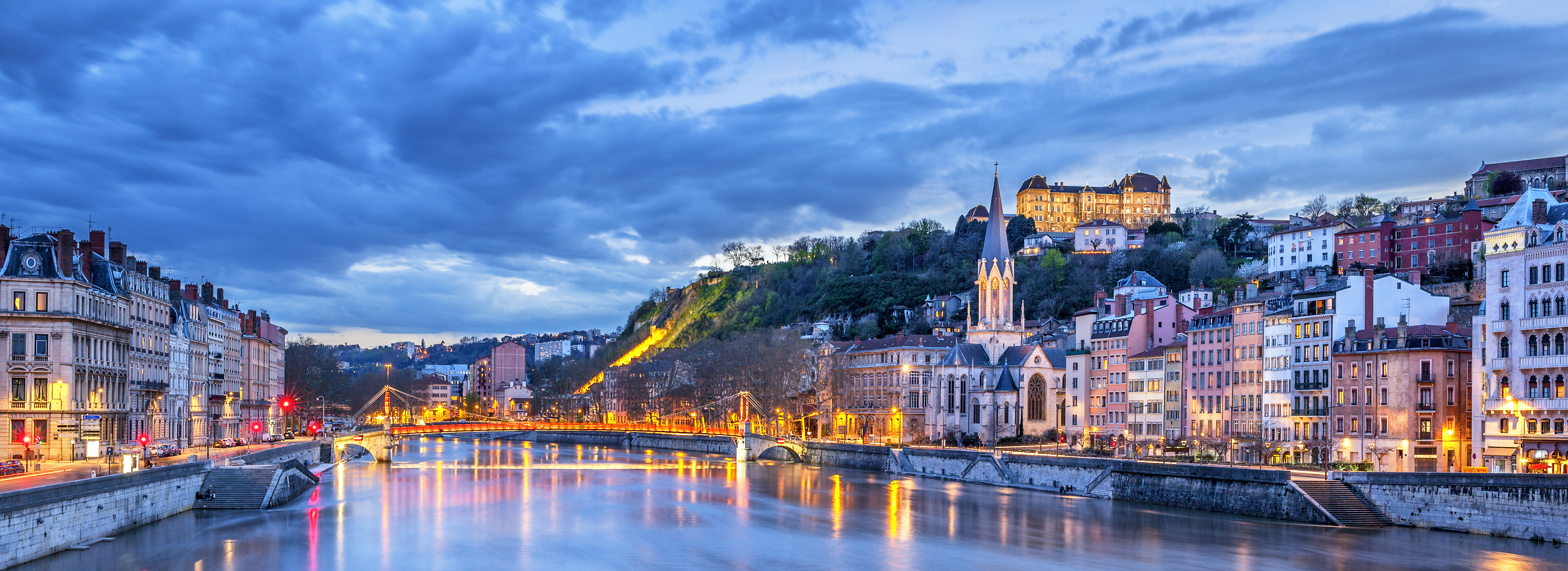 Lyon City Center at night with its historic architecture, red-tiled rooftops, and the winding Rhône and Saône rivers