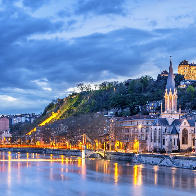 Lyon City Center at night with its historic architecture, red-tiled rooftops, and the winding Rhône and Saône rivers