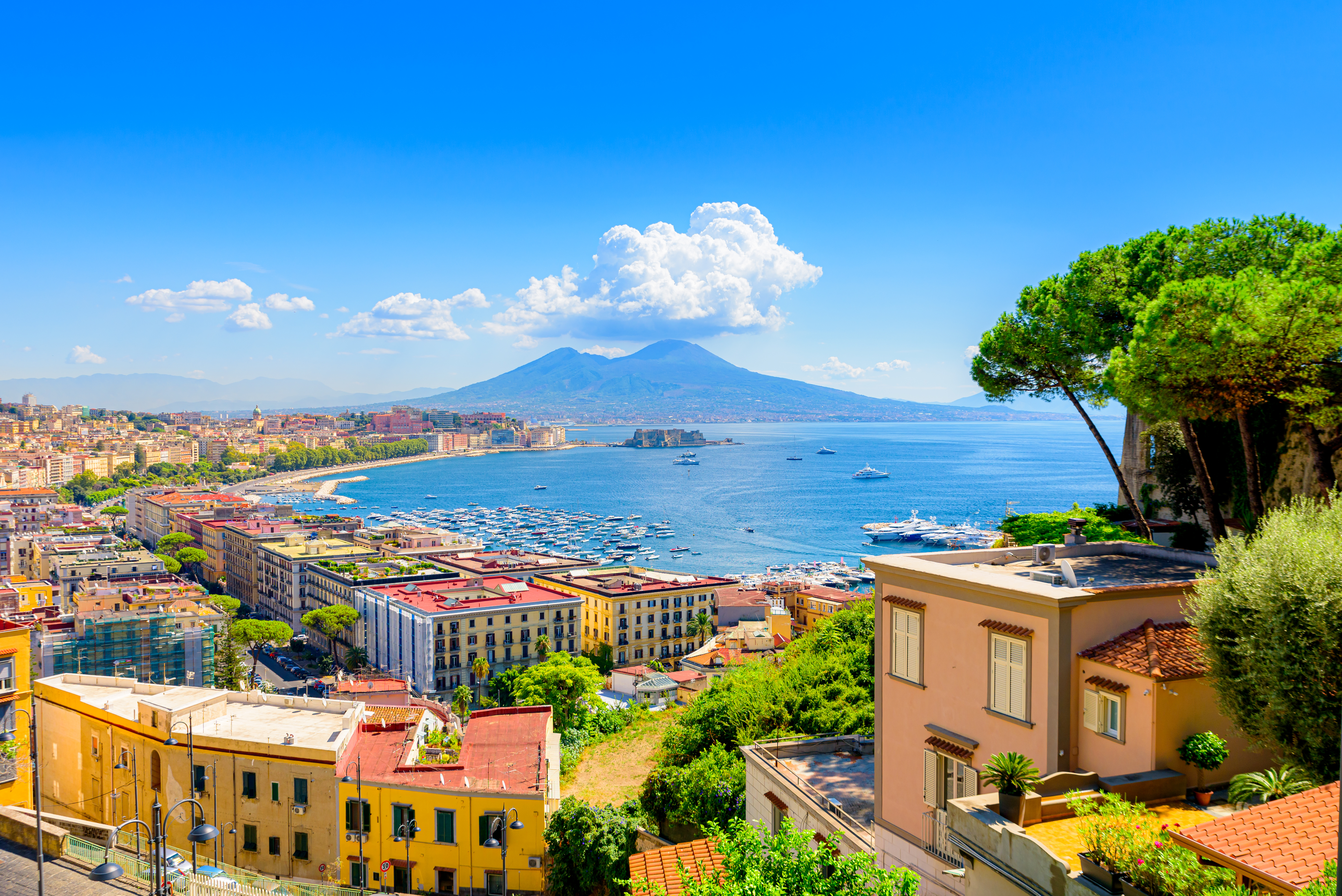 Aerial view of Naples, Italy, with Mount Vesuvius in the background and the sea along the coastline