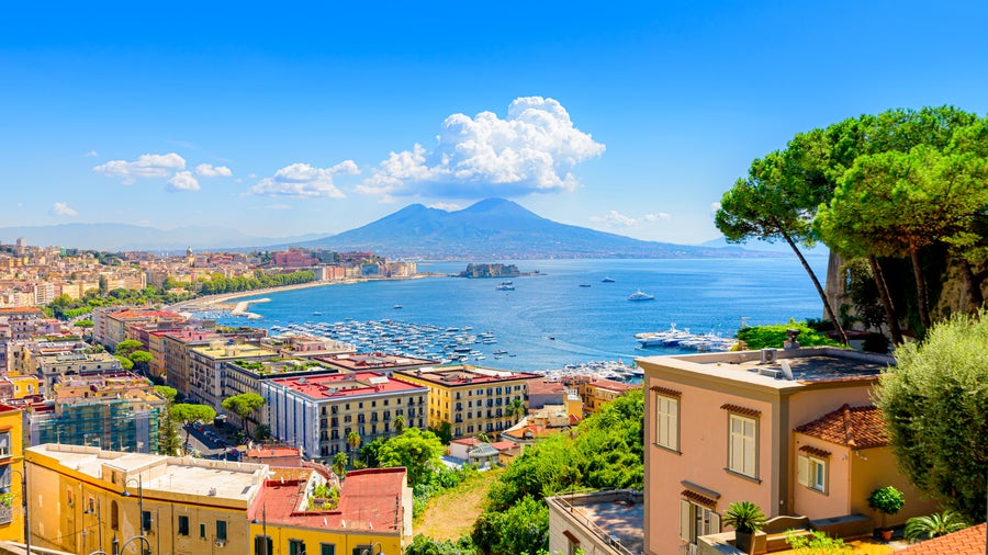 Aerial view of Naples, Italy, with Mount Vesuvius in the background and the sea along the coastline