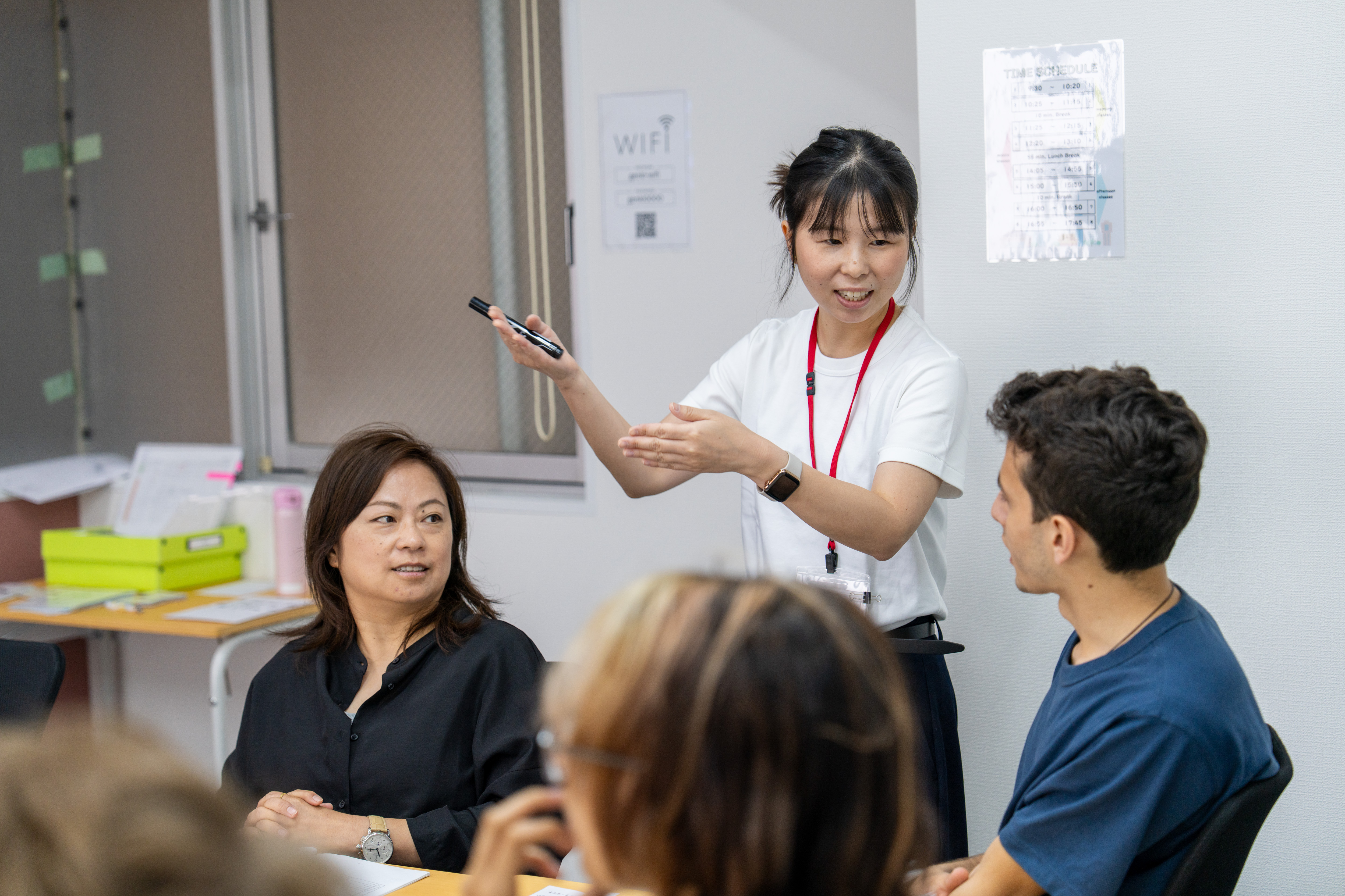 A teacher explaining a lesson to her students at Genki Nagoya